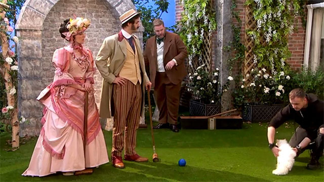 The Goes Wrong Show - Harper's Locket - Bernard Robert Henry Lewis, Celeste Sandra Charlie Russell and Edwin Chris Henry Shields looking at Trevor Chris Leask removing white Persian cat from lawn