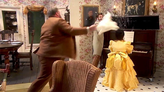 The Goes Wrong Show - Harper's Locket - Bernard Robert Henry Lewis throwing fake white Persian cat at piano with Edwin Chris Henry Shields and Emily Annie Nancy Zamit