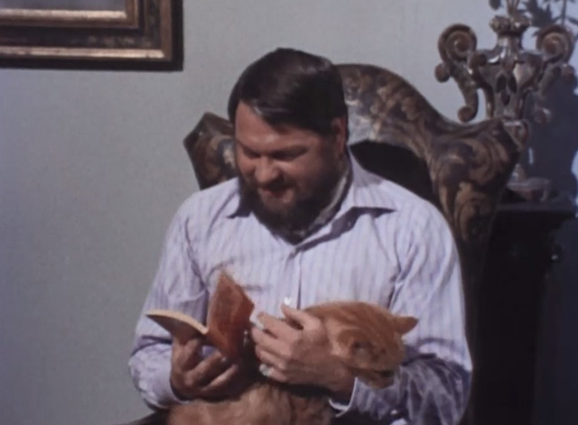 Jason King - That Isn't Me, It's Somebody Else - long-haired ginger tabby cat fidgeting in lap of Bonisalvi George Murcell