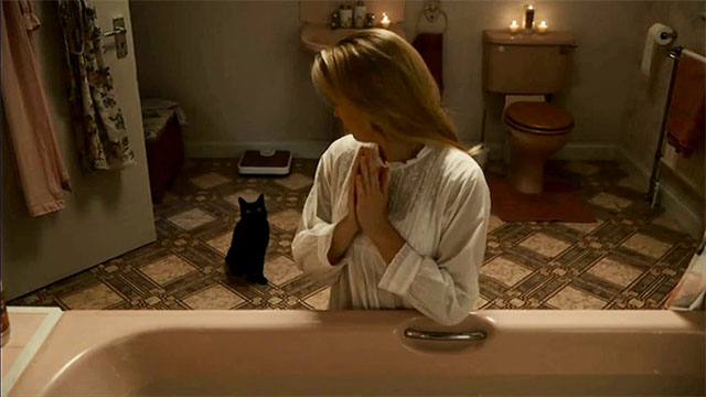 Killing Eve - Just Dunk Me - black cat Lucifer entering bathroom behind Villanelle Jodie Comer
