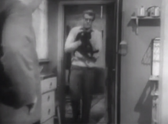 The Larkins - Cat Happy - Jeff Ronan O'Casey carrying black cat Blackie into kitchen