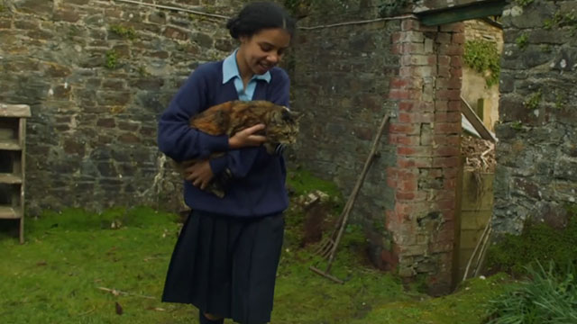 Malory Towers - The Stray - Ellen Carys John carrying torbie cat Kenny through gardens