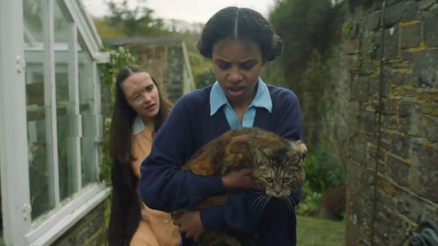 Malory Towers - The Stray - Jean Beth Bradfield following Ellen Carys John carrying torbie cat Kenny through gardens