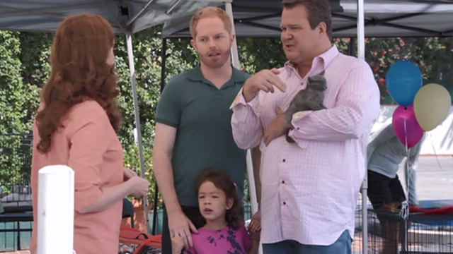 Modern Family - Bringing Up Baby - Mitchell Jesse Tyler Ferguson and Lily Aubrey Anderson-Emmons with Cameron Eric Stonestreet holding gray kitten at adoption fair
