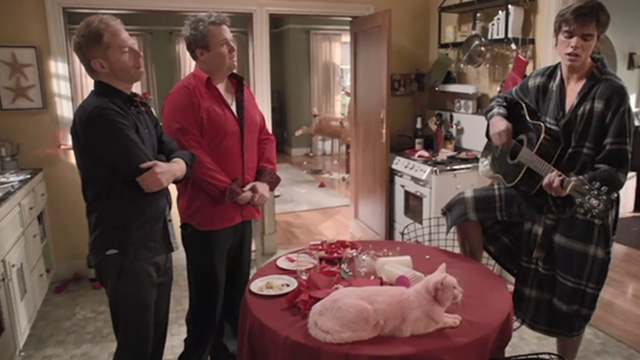 Modern Family - Heart Broken - Cameron Eric Stonestreet and Mitchell Jesse Tyler Ferguson listening to Dylan Reid Ewing singing Tiny Pink Panther with pink Larry Frosty cat on table
