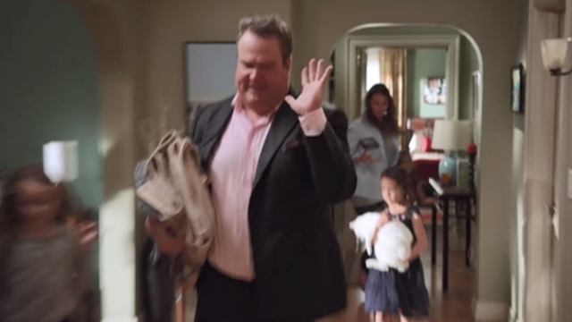 Modern Family - Larry's Wife - Lily Aubrey Anderson-Emmons carrying white cat Larry Frosty inside behind Cameron Eric Stonestreet