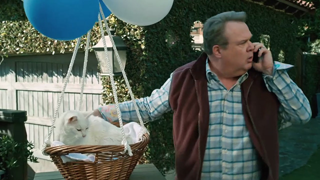 Modern Family - I'm Going to Miss This - Cameron Eric Stonestreet with white cat Larry Frosty in basket tied to balloons