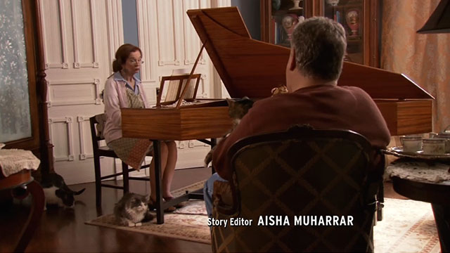 Parks and Recreation - Camping - Elsa Clack Annie O'Donnell playing piano with longhair gray and white and tuxedo cats nearby