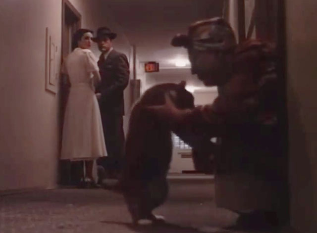 Philip Marlow, Private Eye - Red Wind - Powers Boothe with Lola Linda Griffiths in hallway with woman reaching out to pick up chonky ginger and white tabby cat Leo