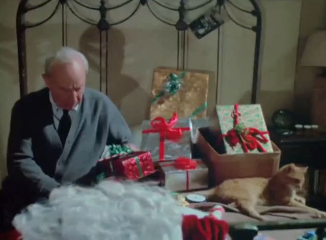 Police Woman - Merry Christmas Waldo - Lloyd Nolan and ginger tabby cat Harry sitting on bed with Christmas presents