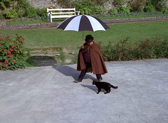 The Prisoner - Dance of the Dead black cat with man and umbrella passing by