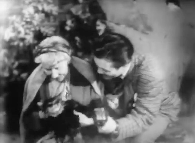 The Quatermass Experiment - Contact Has Been Established - Miss Wilde Katie Johnson holding longhair tabby cat Henry in her lap while being interviewed by BBC reporter Pat McGrath