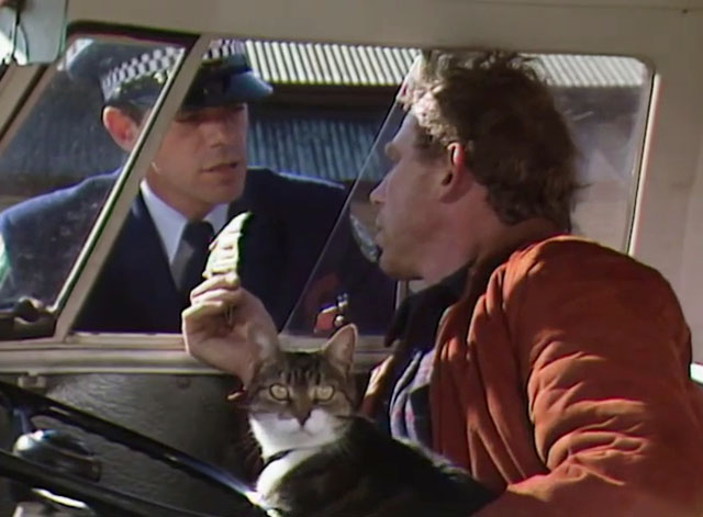 Rafferty's Rules - Unaired Pilot - Rafferty Chris Haywood in van with calico tabby cat talking to policeman