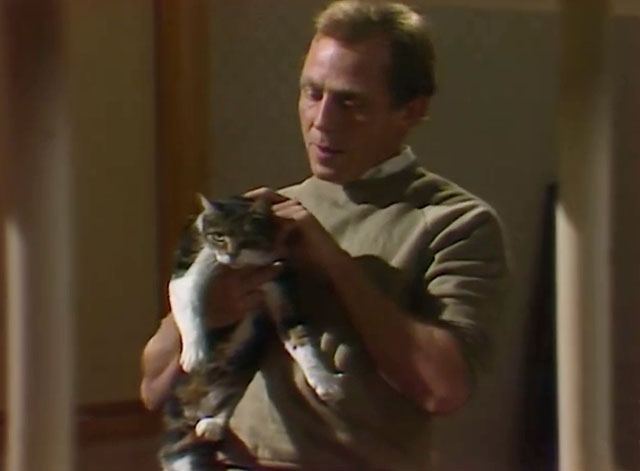 Rafferty's Rules - Unaired Pilot - Rafferty Chris Haywood holding calico tabby cat