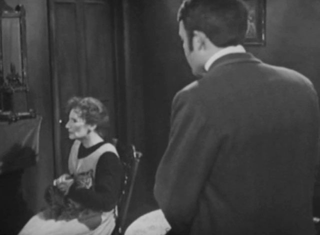 Sergeant Cork - File 2534: The Case of the Public Paragon - Mrs. Archer Ann Tirard sitting in rocking chair with tabby cat on lap as Bob William Gaunt approaches