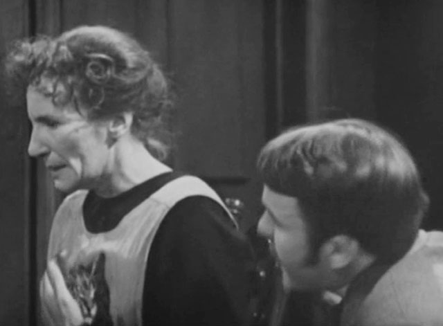 Sergeant Cork - File 2534: The Case of the Public Paragon - Mrs. Archer Ann Tirard sitting in rocking chair with tabby cat on lap and Bob William Gaunt