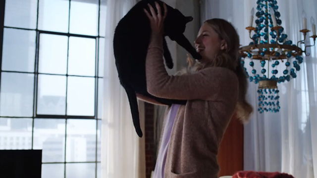 Supergirl - Legion of Super-Heroes - Supergirl Melissa Benoist holding up black cat Streaky