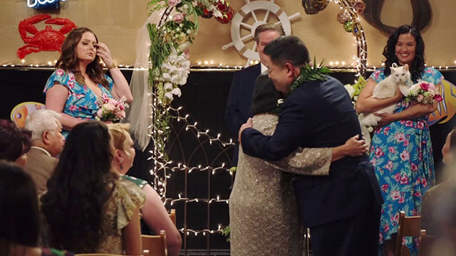Superstore - Sandra's Wedding - bridesmaid holding white cat Biscuit wearing captain's hat as Sandra Kaliko Kauahi and Jerry Chris Grace get married