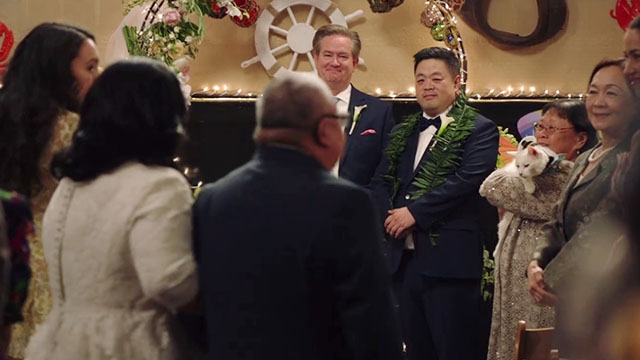 Superstore - Sandra's Wedding - older woman holding white cat Biscuit wearing captain's hat as Sandra Kaliko Kauahi and Jerry Chris Grace get married