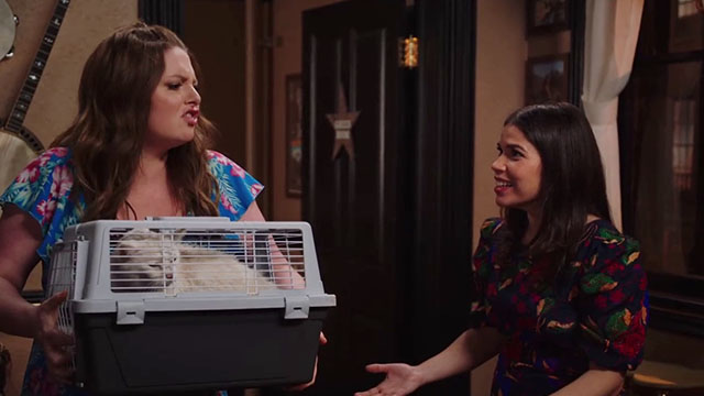 Superstore - Sandra's Wedding - Dina Lauren Ash holding white cat Biscuit in carrier with Amy America Ferrera