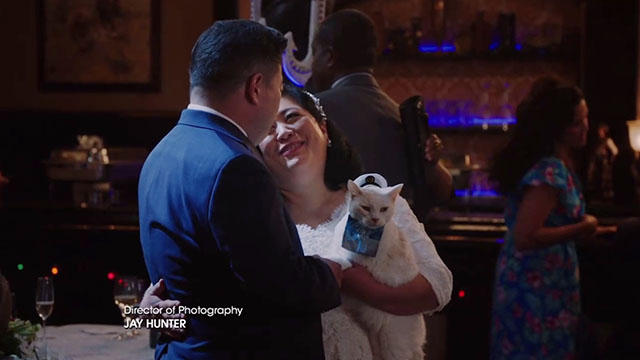 Superstore - Sandra's Wedding - Sandra Kaliko Kauahi and Jerry Chris Grace dancing with white cat Biscuit