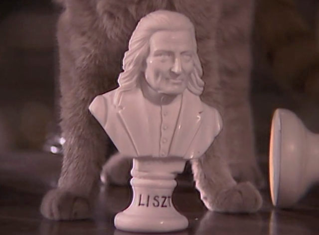 Tales of the Unexpected - Edward the Conqueror - paws of ginger tabby cat behind bust of Liszt