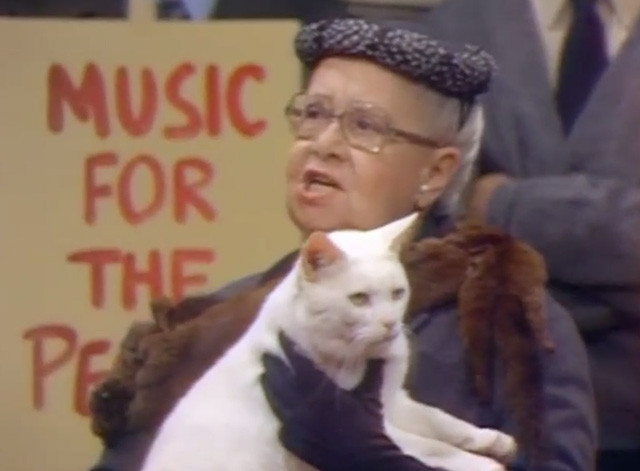 WKRP in Cincinnati - Pilot: Part 2 - close of old woman protestor Mrs. Burstyn Nedra Volz holding white cat Mr. Harrison