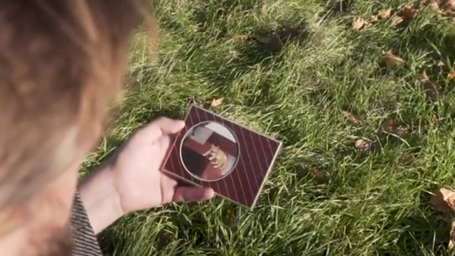 Ages - Ross Blake - man holding photo of ginger and white cat in frame