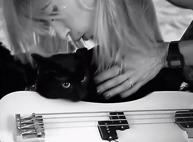 Kool Thing - Sonic Youth - Kim Gordon petting black cat near guitar