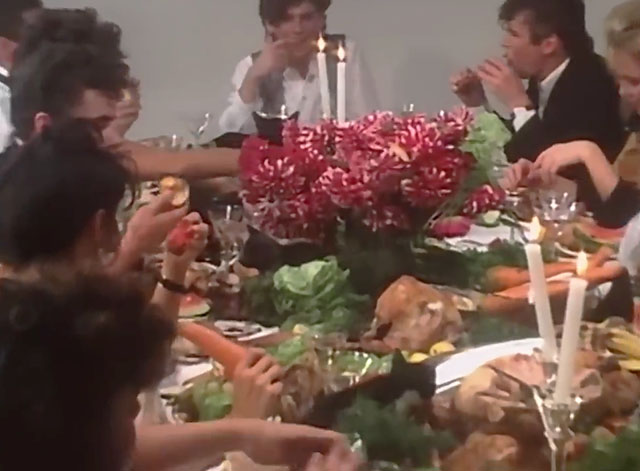 The One Thing - INXS - band members with women and cats feasting at table